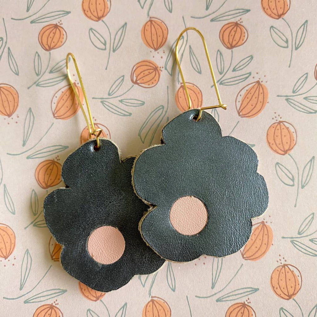 Aretes de cuero recuperado reversibles en forma de margarita. Diseño costarricense. Joyería artesanal contemporánea sostenible. Joyería de autor. 