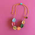 Collar de cuero recuperado inspirado en la forma orgánica de la fruta Uchuva. Diseño de Costa Rica. Joyería Sostenible artesanal. 